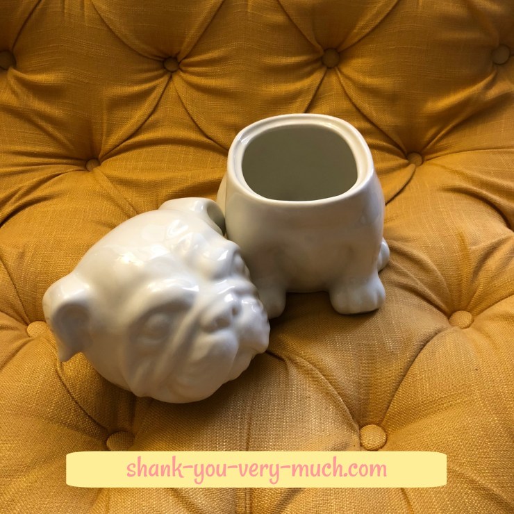 A bulldog cookie jar with the head removed